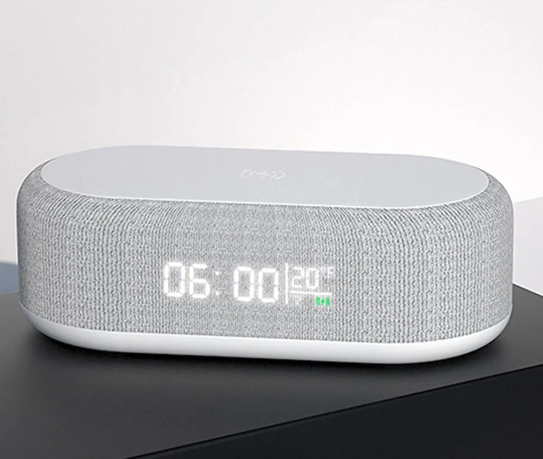 Wireless charging alarm clock with 3 in 1 functions shown in white on black surface
